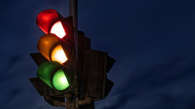 Acelerar no amarelo/início do vermelho é perigoso, pois a luz verde já pode ter acendido para pedestres ou ciclistas, causando acidentes graves/Pexels