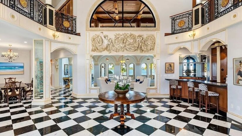 A entrada grandiosa de dois andares tem detalhes em ouro 24 quilates e vista para a água/ Realtor.com