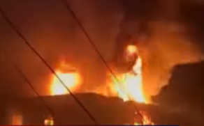 A imagem mostra um incêndio em uma fabrica de velas