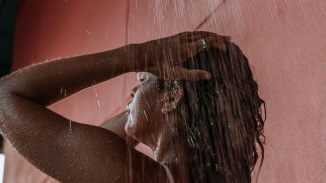 Mulher tomando banho e lavando os cabelos