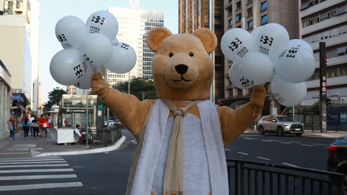 O urso mascote da feira da moda de inverno posa na Avenida Paulista
