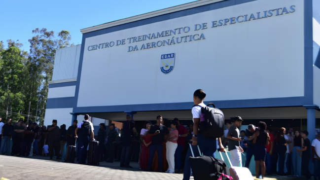 A segunda imagem mostra a fachada de um prédio moderno pintado em tons de branco e azul, identificado pela inscrição metálica em destaque: "CENTRO DE TREINAMENTO DE ESPECIALISTAS DA AERONÁUTICA" e, logo abaixo, o logotipo azul e branco com a sigla EEAR. Em frente à entrada, há uma grande movimentação de pessoas. Vários jovens e civis, alguns carregando malas de viagem e mochilas, circulam ou aguardam no local em um dia ensolarado, indicando um momento de recepção, apresentação ou início de atividades na instituição.
