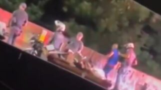 As imagens mostram três agentes da Polícia Militar próximos a uma motocicleta caída no chão