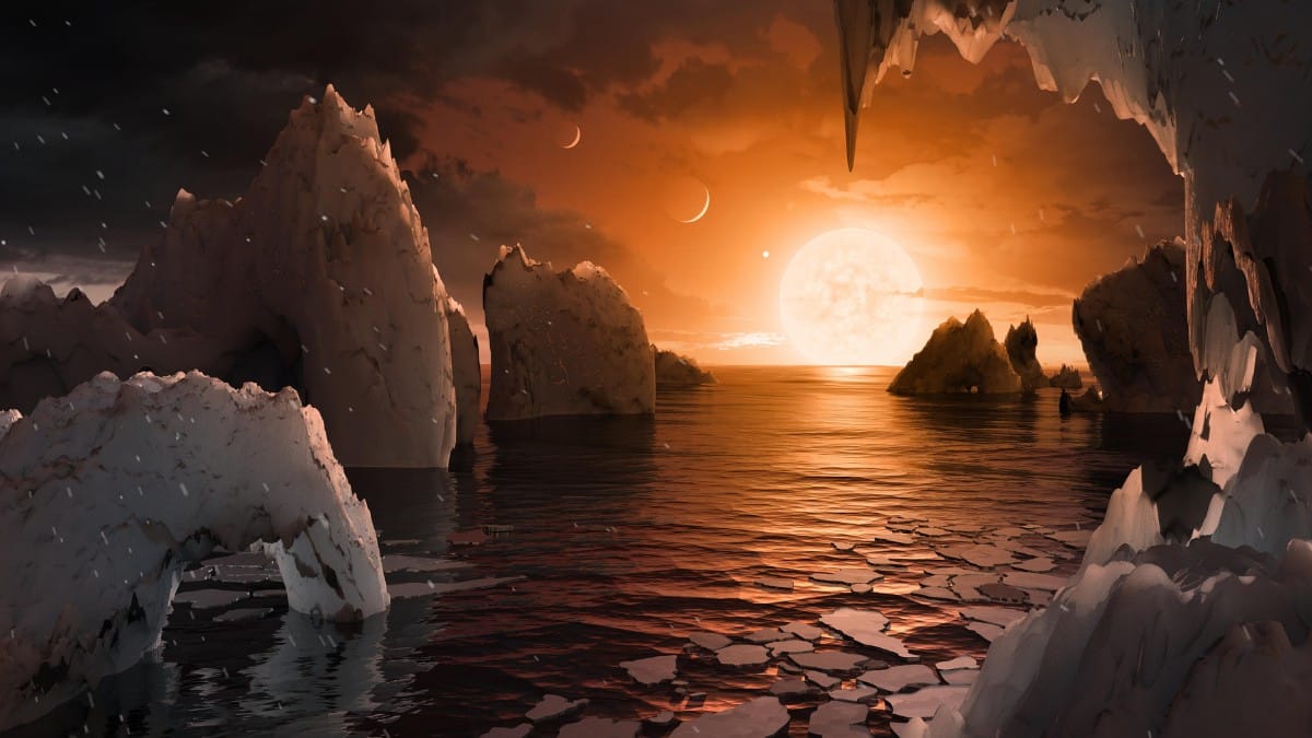 Conceito artístico permite imaginar como seria estar na superfície do exoplaneta TRAPPIST-1f. A região do terminador divide permanentemente o lado diurno do noturno, criando áreas de gelo e água líquida / NASA/JPL-Caltech