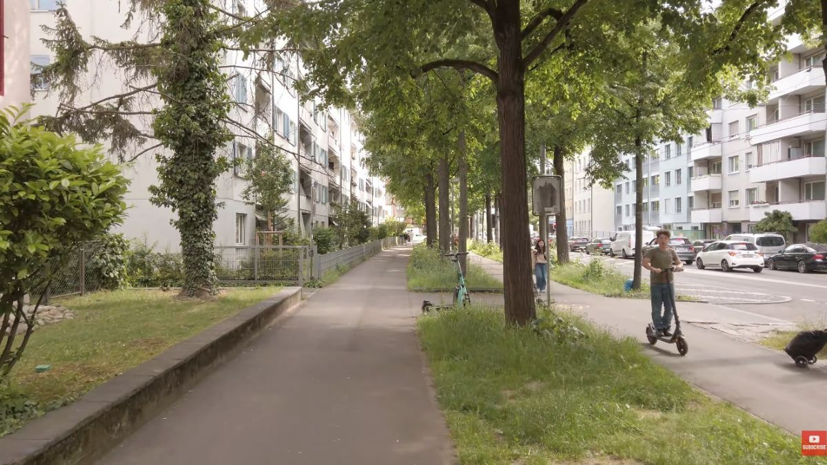 Rua comum de Basileia, onde o cotidiano segue com segurança, infraestrutura completa e serviços públicos presentes uma realidade distante de qualquer cenário de precariedade