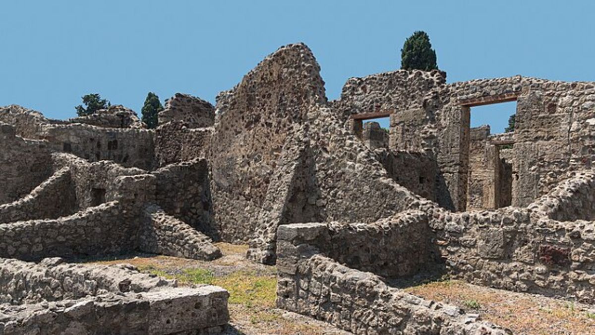 Hoje, Pompeia é um sítio arqueológico coberto por cinzas vulcânicas, onde ruínas, monumentos e moldes de corpos humanos revelam os impactos da erupção do Vesúvio. Wikimedia Commons/Jebulon