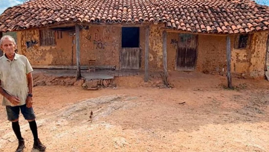 Milan, de 80 anos, na frente da sua casa de argila, onde mora sozinho